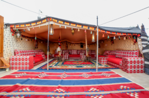 People in the desert in a tent